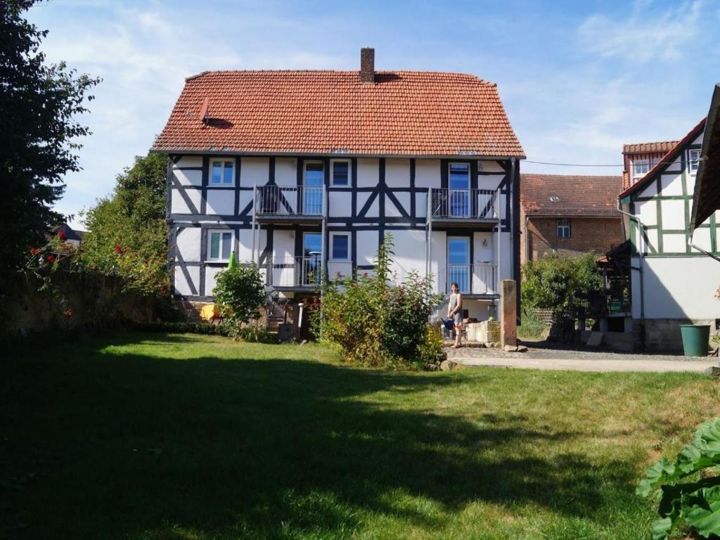 a white and black house with a red roof at Gästehaus Minkel in Gudensberg