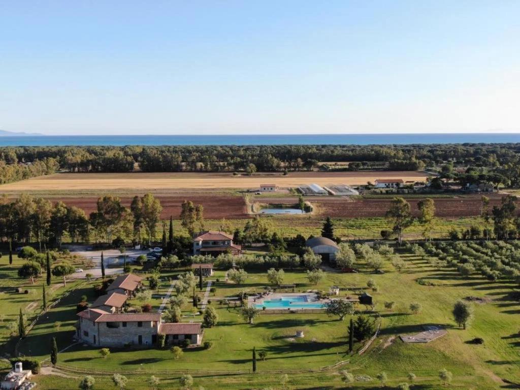 an aerial view of a farm with a pool at Vento di Maremma in Marina di Grosseto
