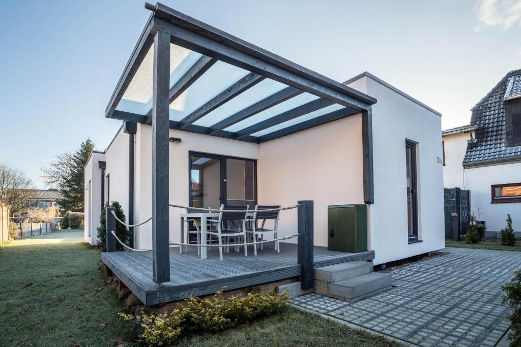 a small white house with a wooden deck at Ferienhaus Spaden in Spaden