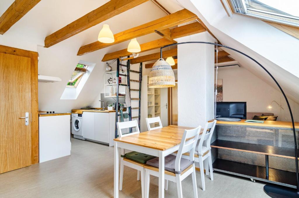 a kitchen and dining room with a table and chairs at Marienstraße, 54m², ruhig gelegen in Herdwangen-Schönach