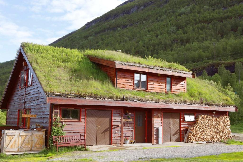 a log cabin with a grass roof at Guesthouse / Huskyfarm Innset in Innset