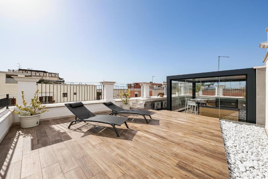 a balcony with two chairs and a table on a roof at Orchidea Celeste Bed and Breakfast in Manfredonia