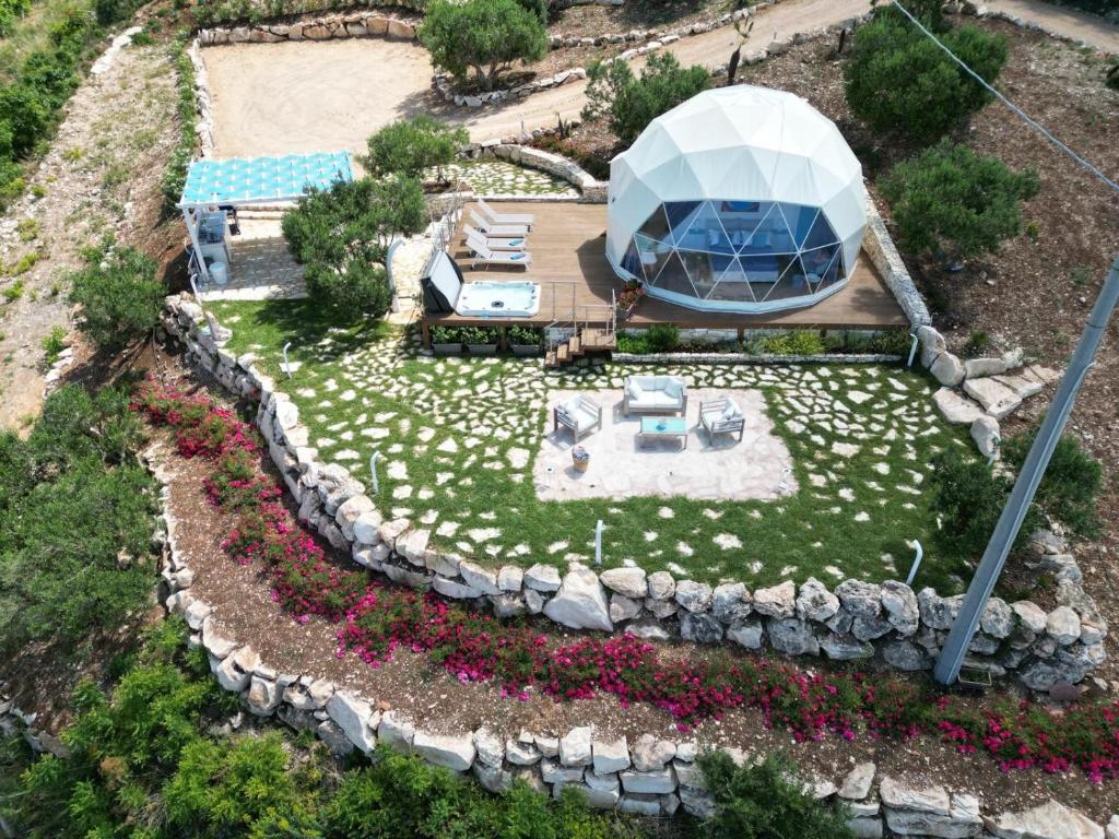 an overhead view of a garden with a circular building at Dome on the hill with Jacuzzi in Castellammare del Golfo