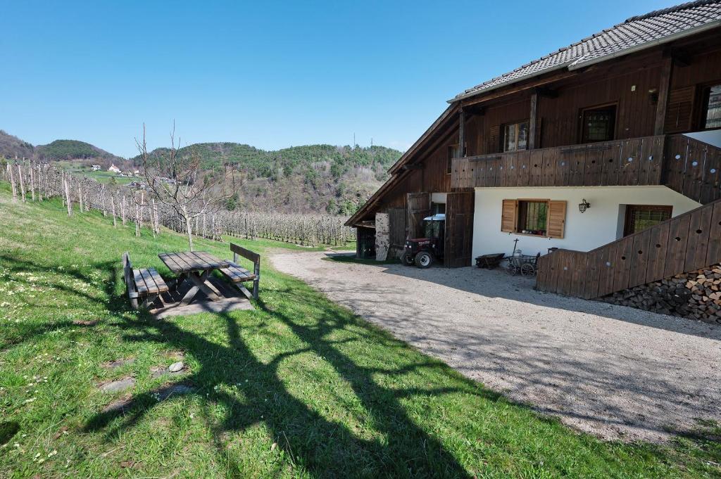 a bench sitting in front of a barn at Regalterhof Eppan in San Paolo