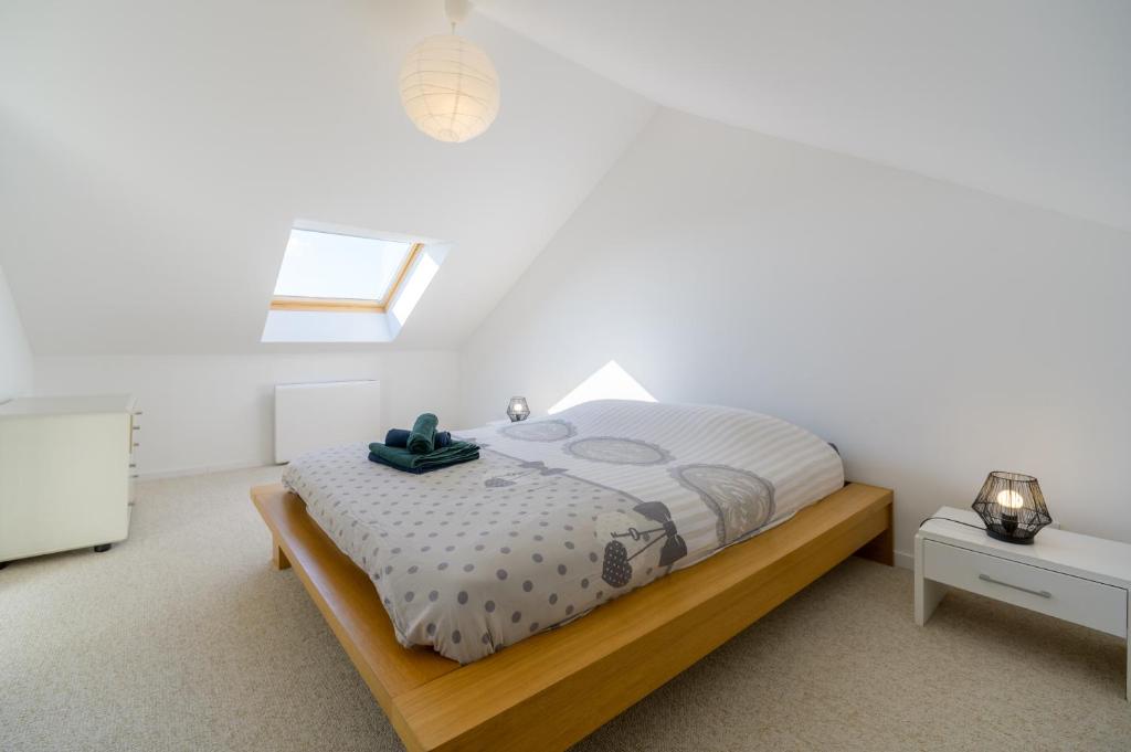 a bedroom with a bed and a window at Le Gite De Luca in Husseren-les-Châteaux