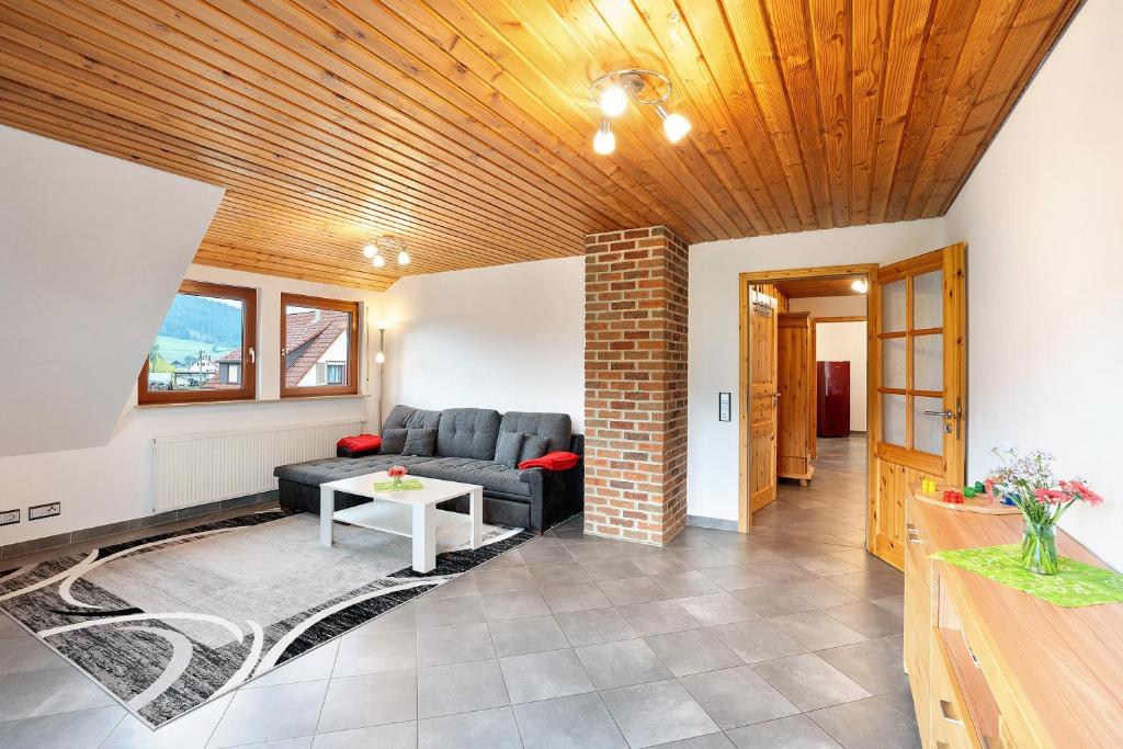 a living room with a couch and a table at Wohnung Kuhblick in Baiersbronn