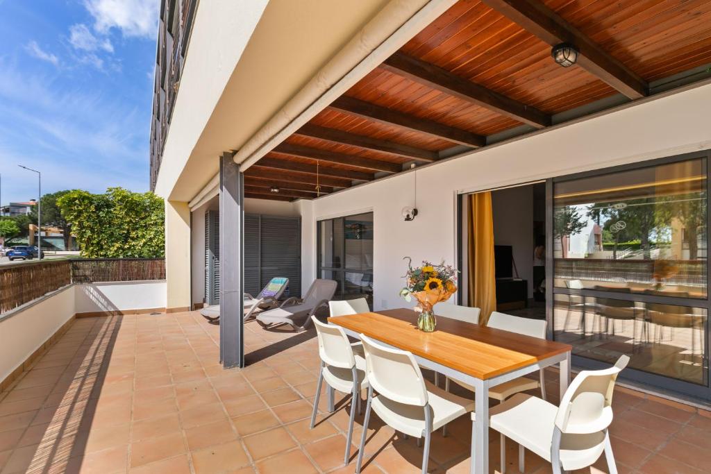 an outdoor patio with a wooden table and chairs at Marina park Apartment in Lagos