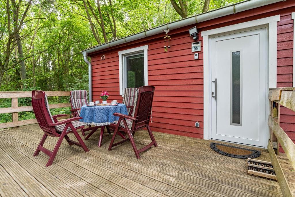 a table and chairs on the deck of a cabin at Bungalow Passat - Bgl 5 in Dranske