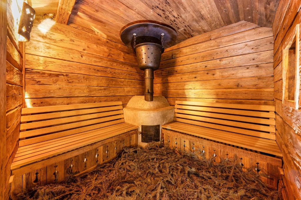 a sauna with two benches in a wooden room at Naturoase Stegerhof Apt Margerite in Trodena