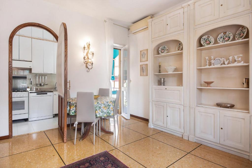 a kitchen and dining room with a table and chairs at Casa Parco Casale in Rapallo
