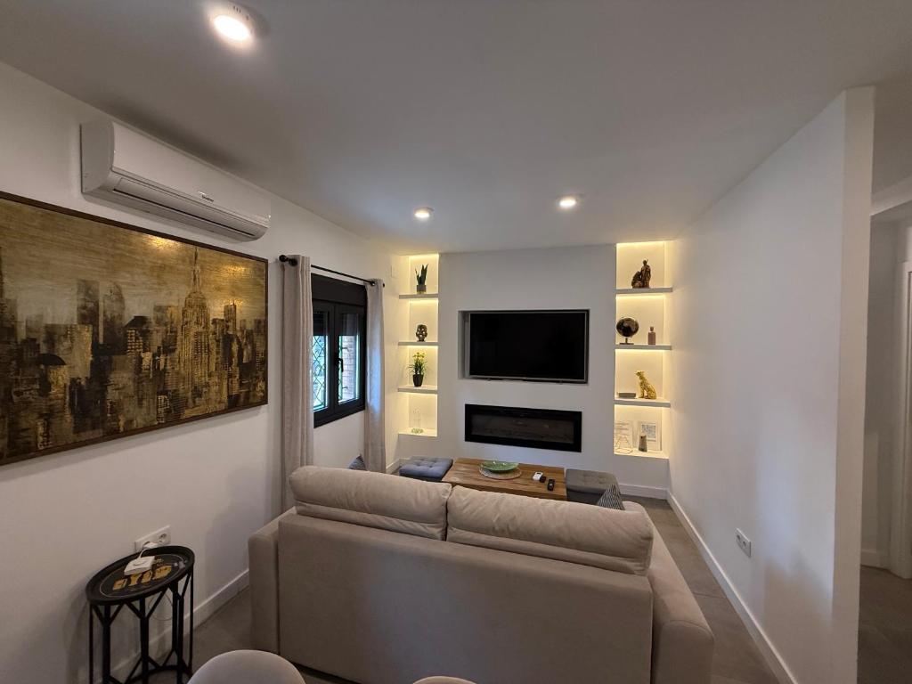 a living room with a couch and a flat screen tv at Luis Montoto in Seville