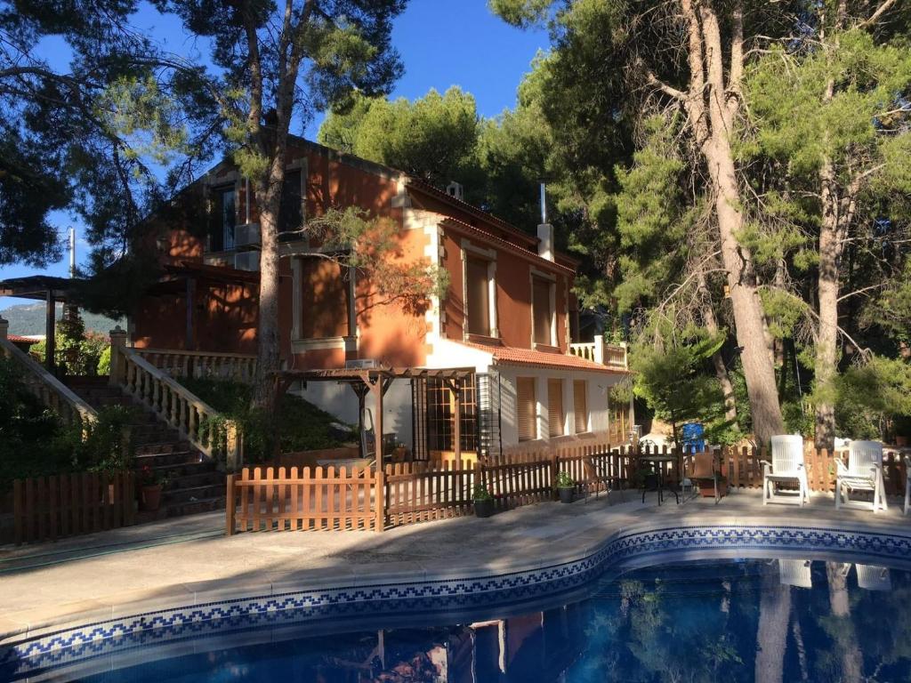 a house with a pool in front of it at El Pinar de la Loma in Moratalla