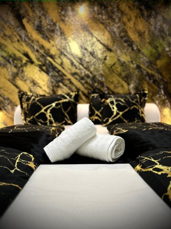 a roll of thread sitting on a bed with pillows at Deluxe - Apartment 'Andrei 2' in Neuburg an der Donau