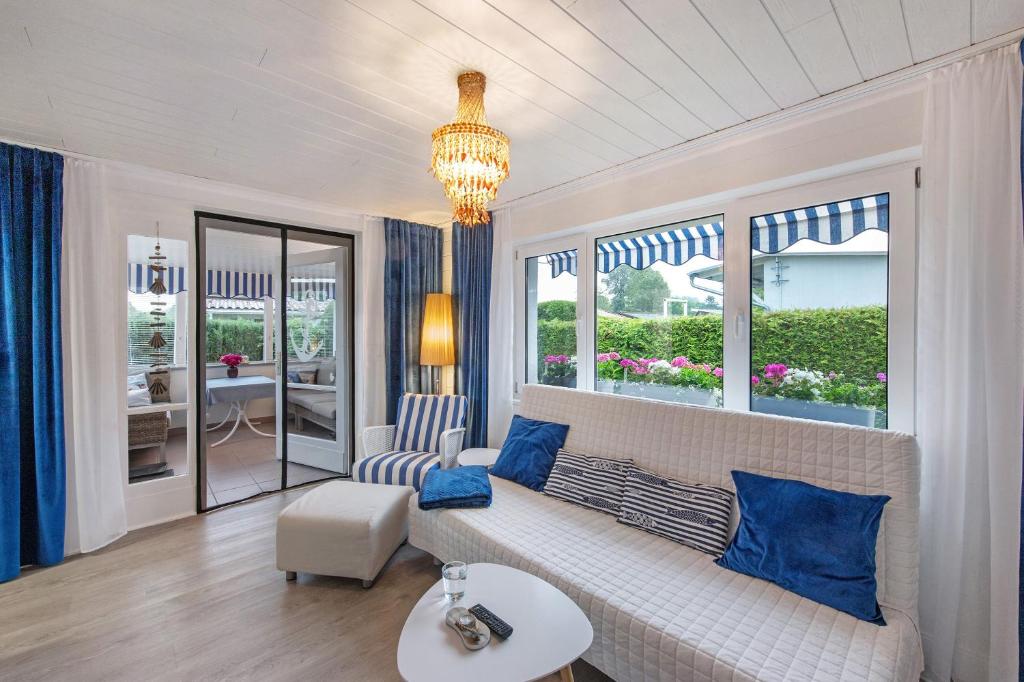 a living room with a white couch and blue pillows at Ruheoase Kummerower See in Kummerow
