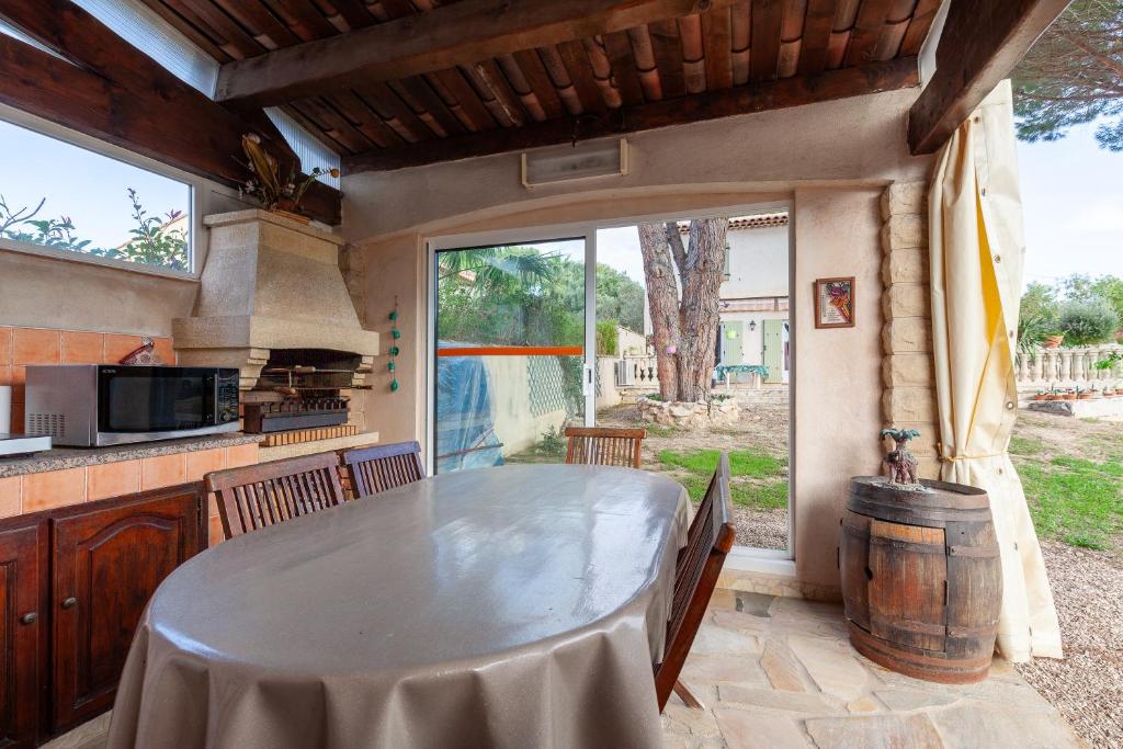 a kitchen with a table and a large window at Appart Côte bleue avec jardin in Martigues