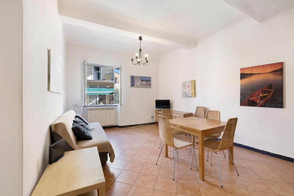 a living room with a table and chairs and a couch at Casa Federico in Levanto