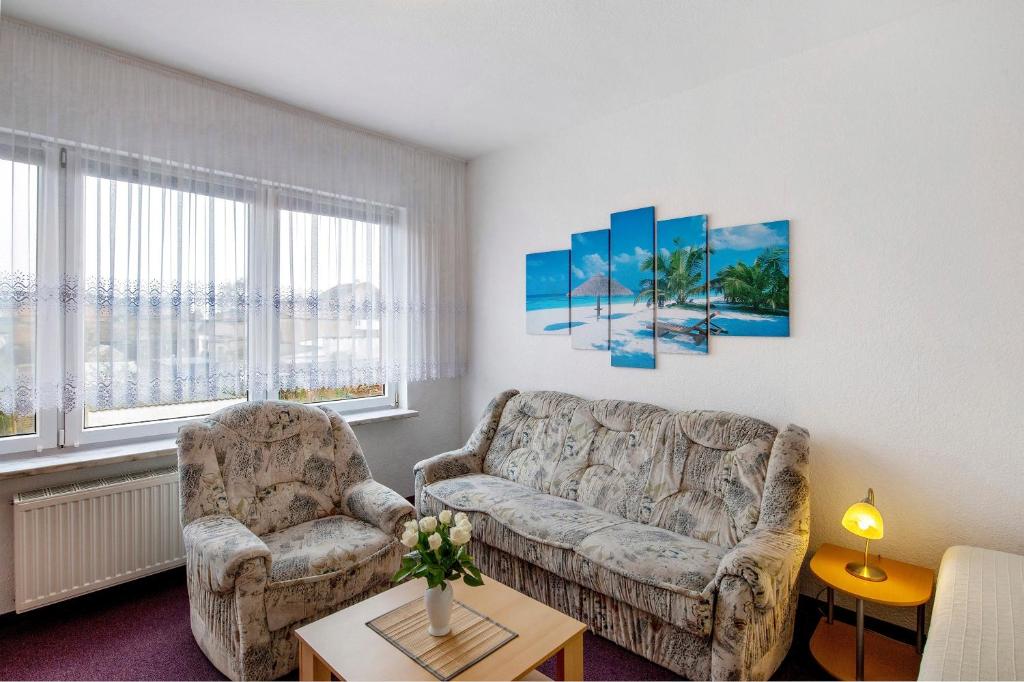 a living room with a couch and a chair at Ferienwohnung Laage in Laage