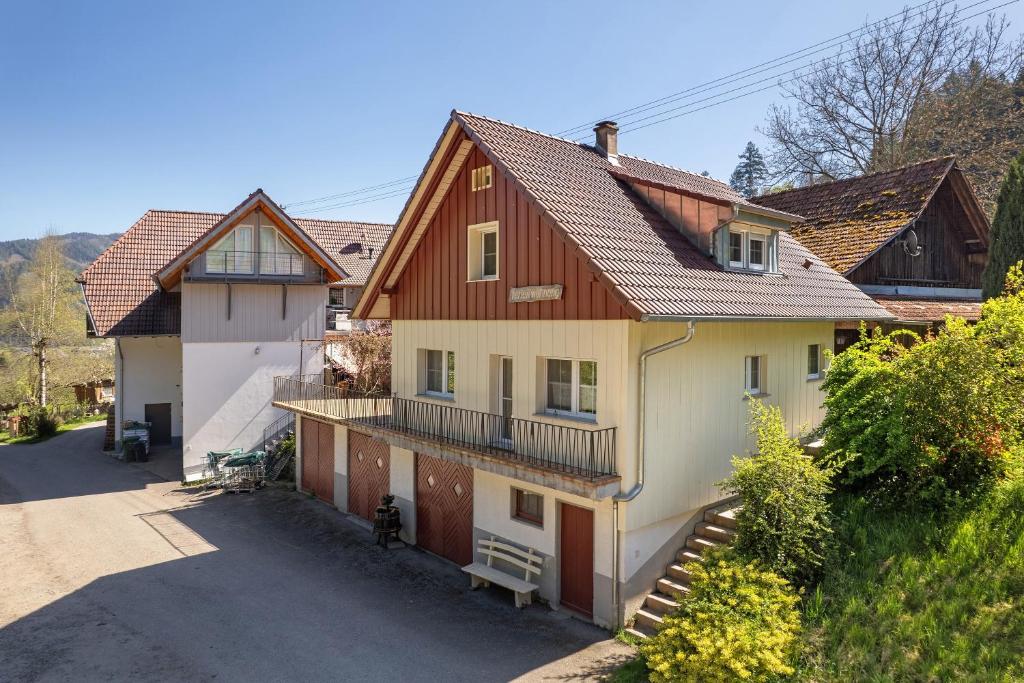 a large house with a balcony on a street at Müllerleile Hof in Haslach im Kinzigtal