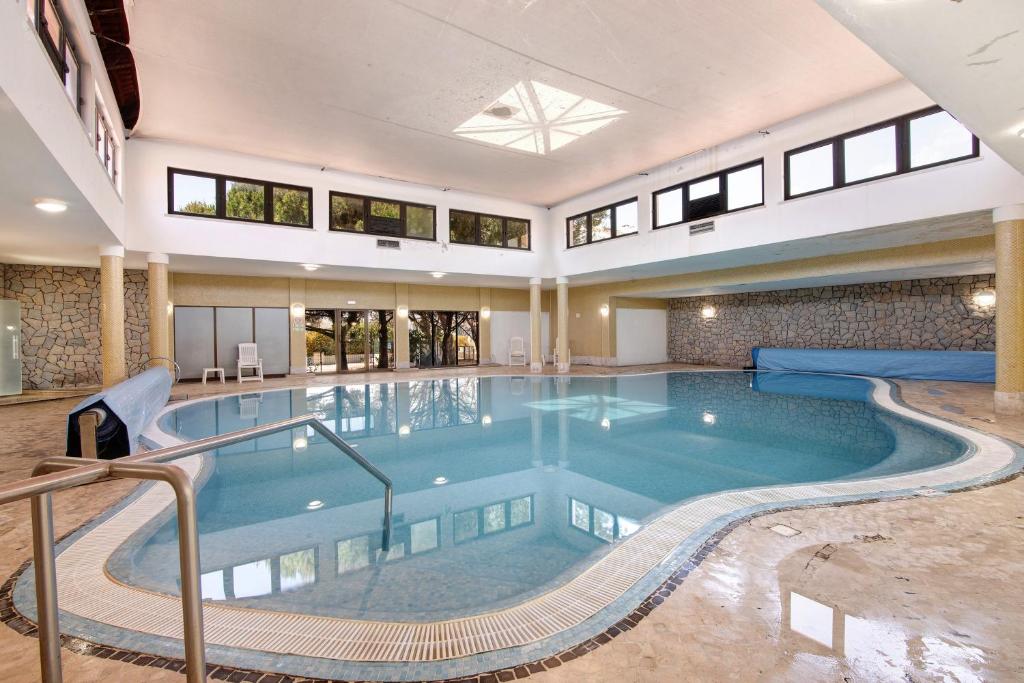 a large swimming pool in a building at Casa Diouma in Cabanas de Tavira