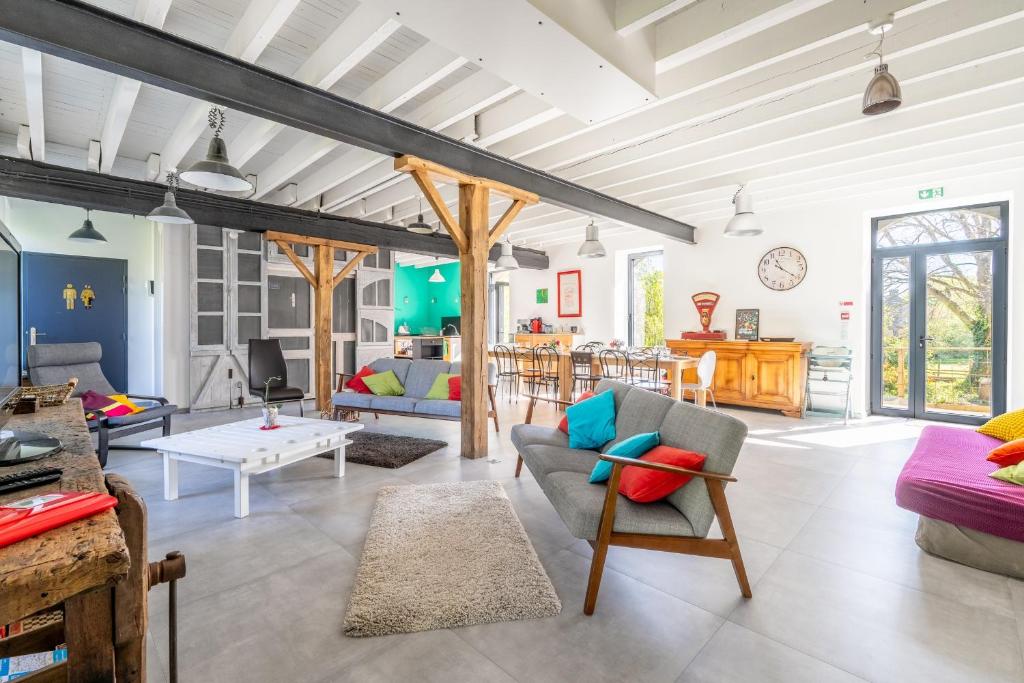 a living room with a couch and a table at L'Erdre au moulin in Joué-sur-Erdre