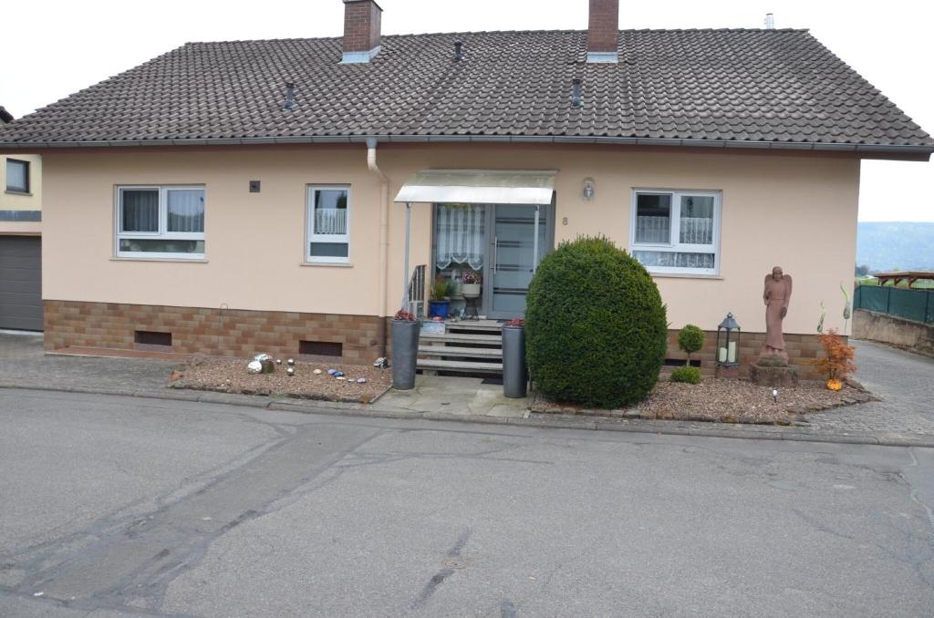 aige house with a porch and stairs in front of it at Collenberger Ferienwohnung Schäfer in Collenberg