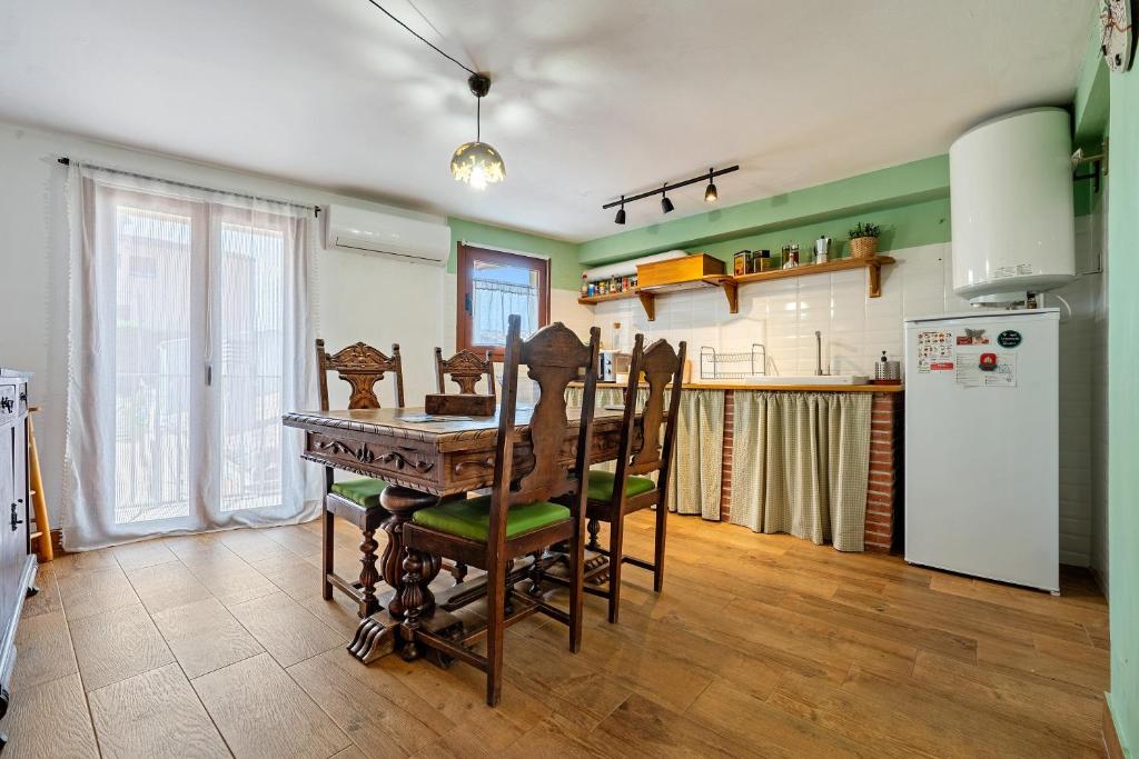 a kitchen with a table and chairs and a refrigerator at L'Escambell Grau Del Llop in Ulldemolins