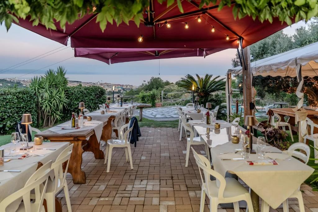 a restaurant with tables and chairs with a view at Agriotto Agriturismo in Savona