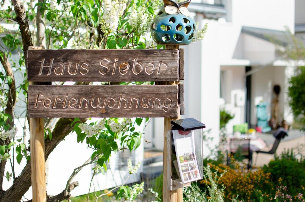 a sign in front of a house with a houseoster forgiving at Haus Sieber in Schiltach