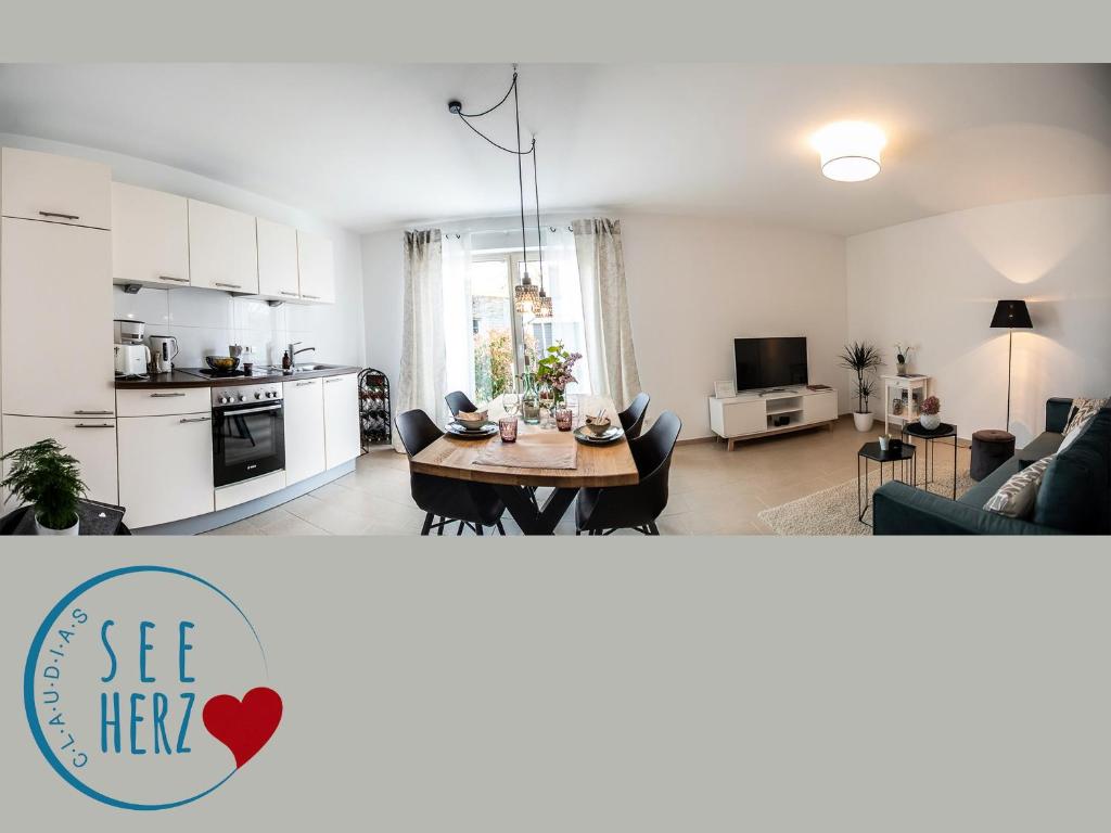 a kitchen and a living room with a table at Claudia's Seeherz in Wasserburg
