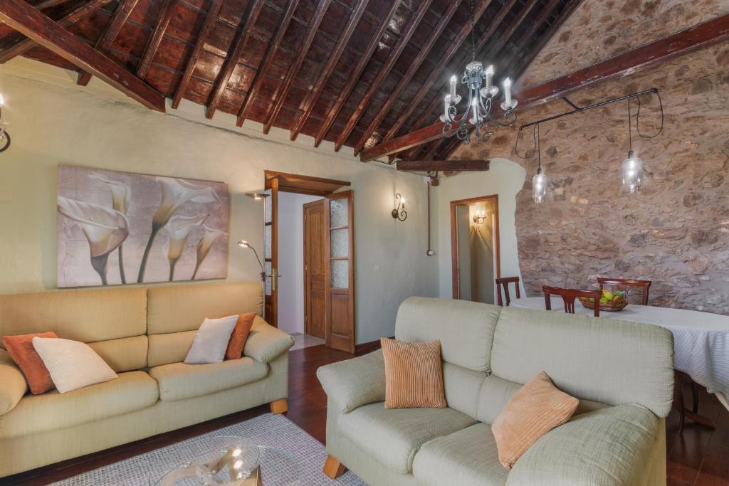 a living room with a couch and a table at Casa Isabel in Santa Brígida