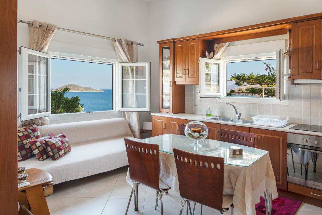 a kitchen and living room with a couch and a table at Anna House in Panteli