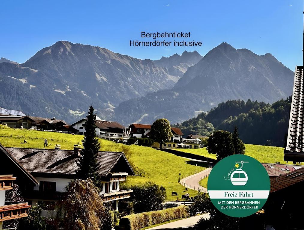 a view of a village with mountains in the background at Ferienwohnung Bergrose in Obermaiselstein