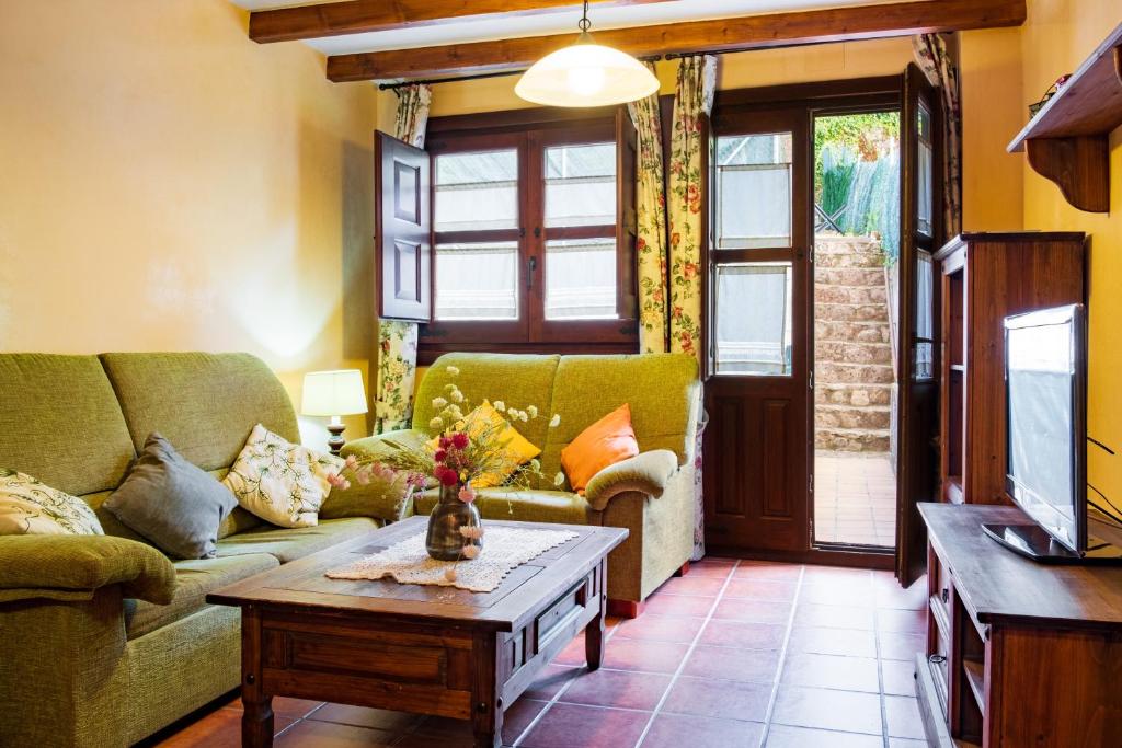 a living room with a couch and a coffee table at Las Puentes 2 in Candelario