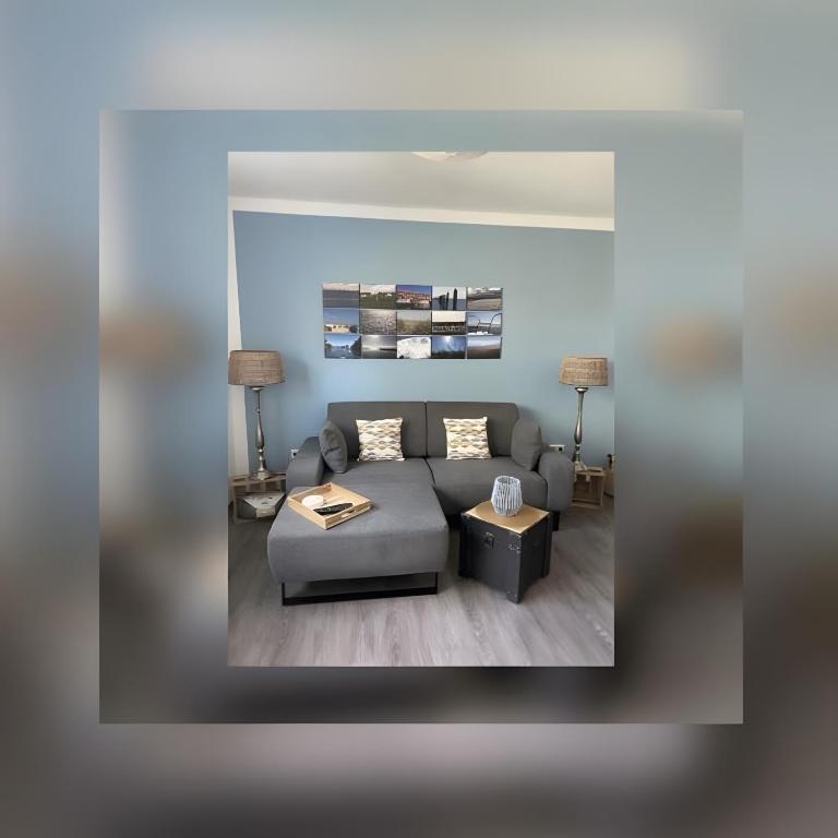 a living room with a couch and a table at Ferienwohnungen Felix und Jan in Horumersiel