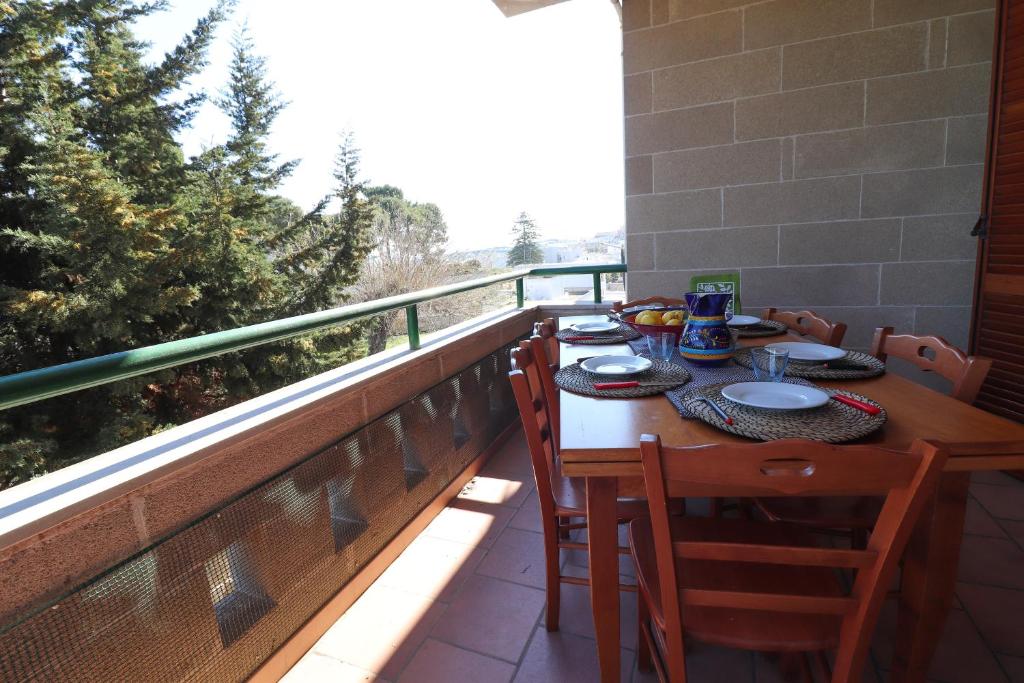 a table on a balcony with food on it at Casa Zara a Otranto in Otranto