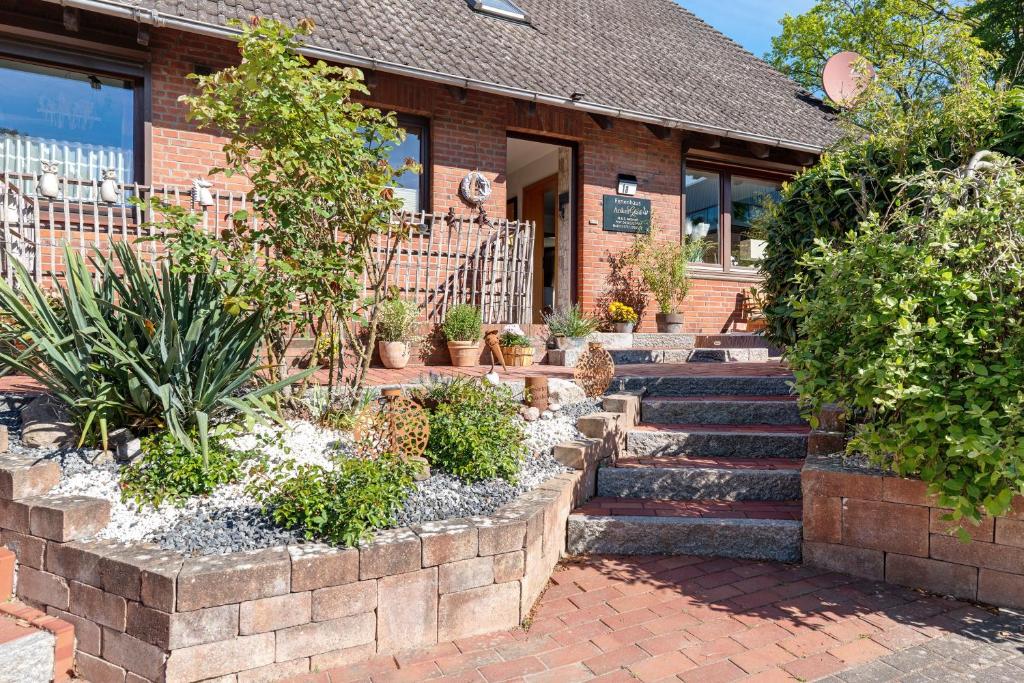 a brick building with stairs and plants in front of it at Ferienhaus Ankerglück in Lensahn