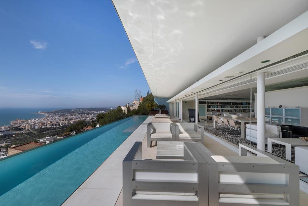 a view of a swimming pool from the balcony of a house at Casa Nirvana - Penthouse in Sitges