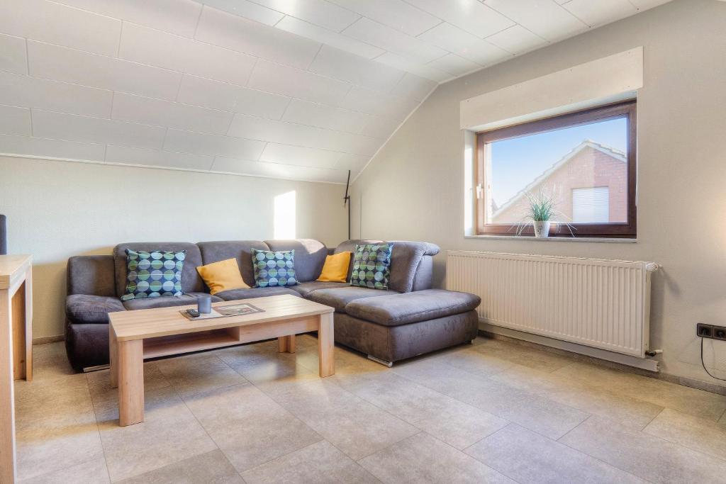 a living room with a couch and a table at Mill Nordkirchen in Nordkirchen