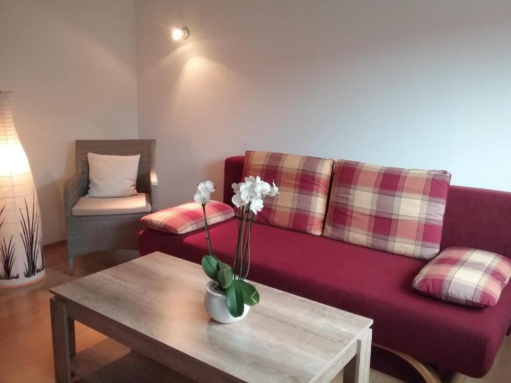 a living room with a purple couch and a table at Haus Mühlgrund in Bad Wildbad