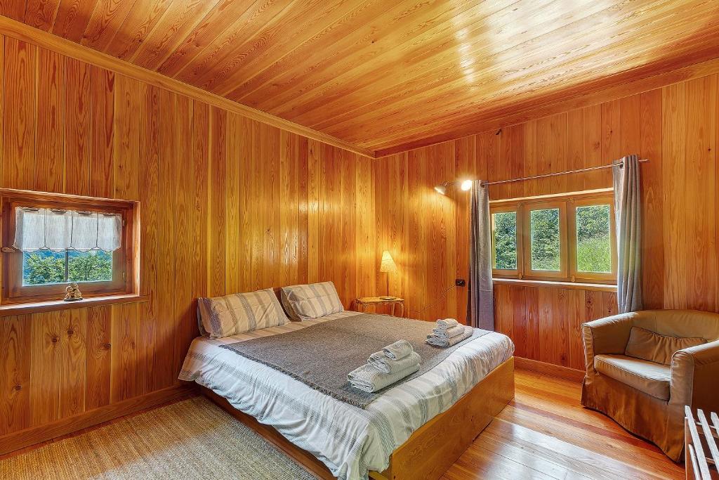 a bedroom with a bed in a wooden room at La Libellula in Scopello
