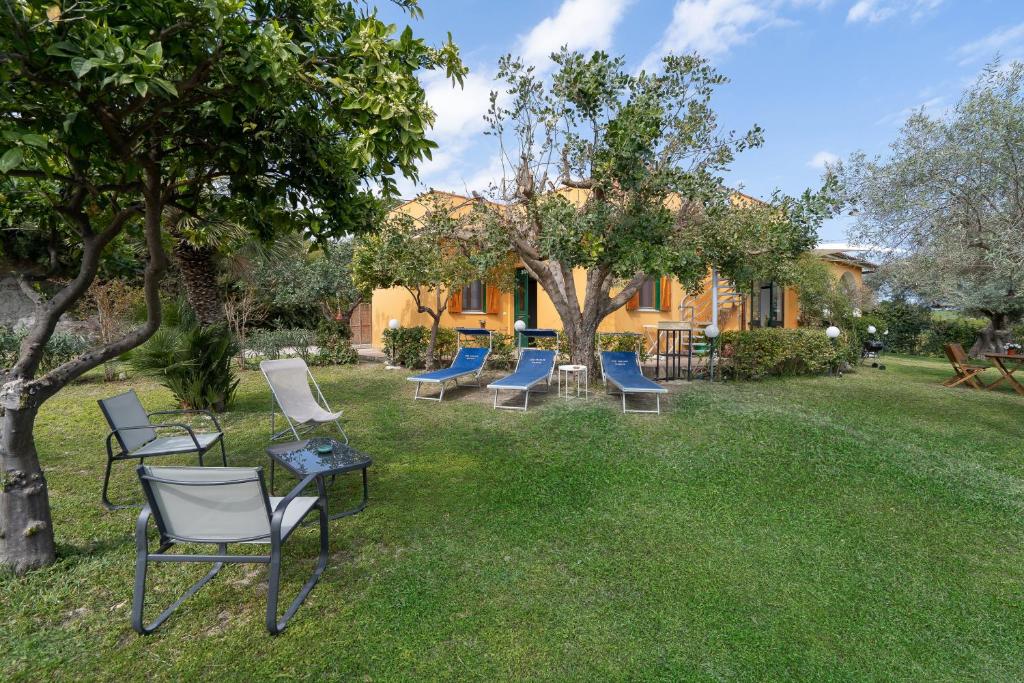 a group of chairs and tables in a yard at Ciumara West in Avola