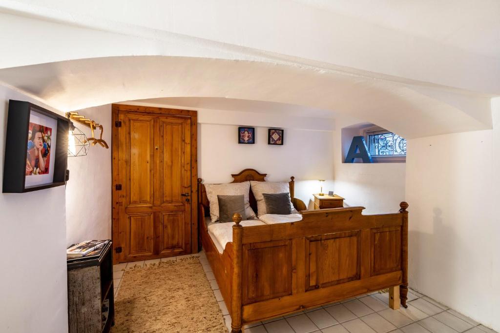 a bedroom with a wooden bed in a room at Briller Gewölbe in Wuppertal