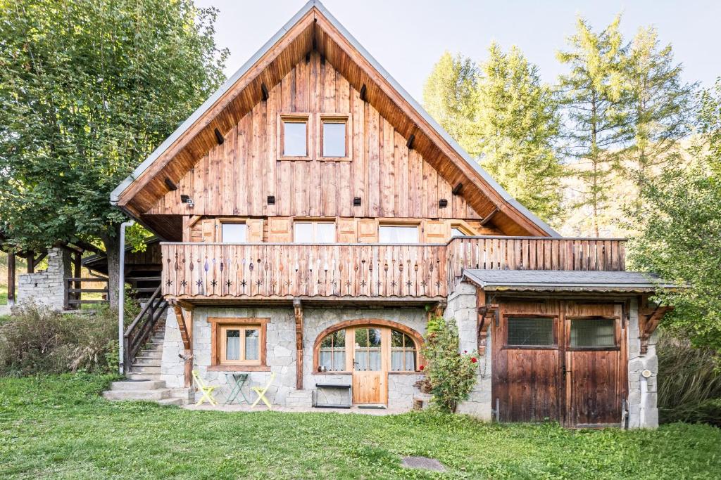 a large wooden house with a garage at Le Chalet Jarrier in Jarrier