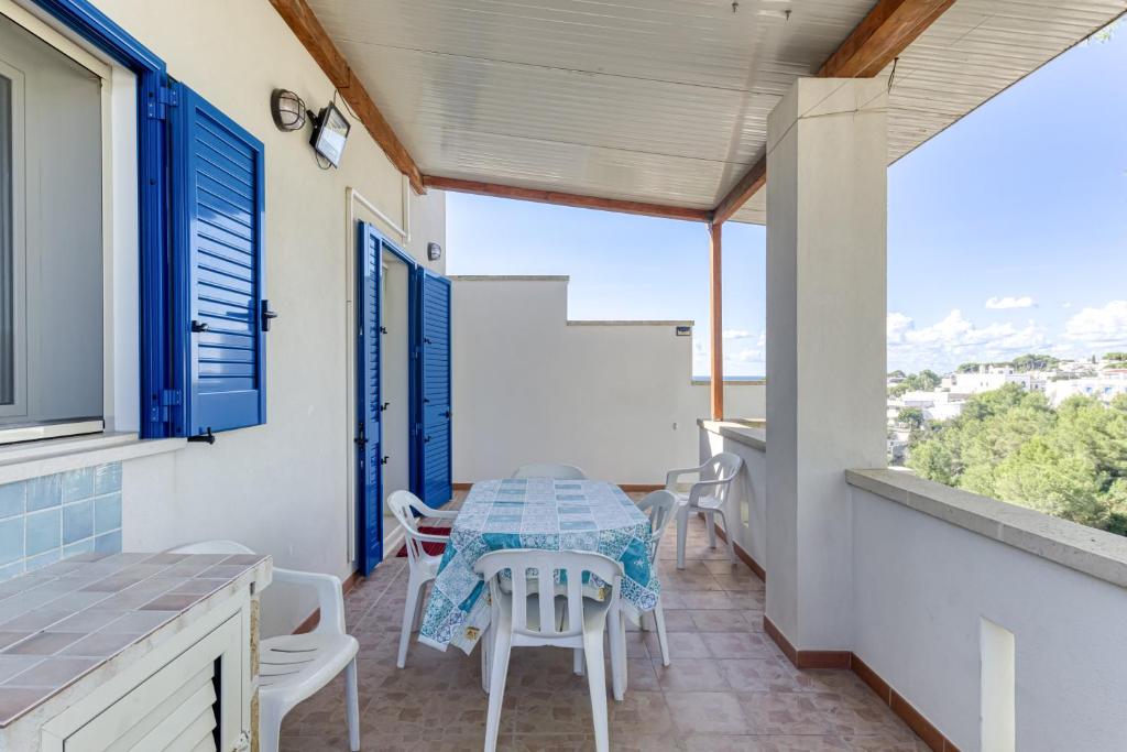 a patio with a table and chairs on a balcony at E case e Leviche in Castrignano del Capo