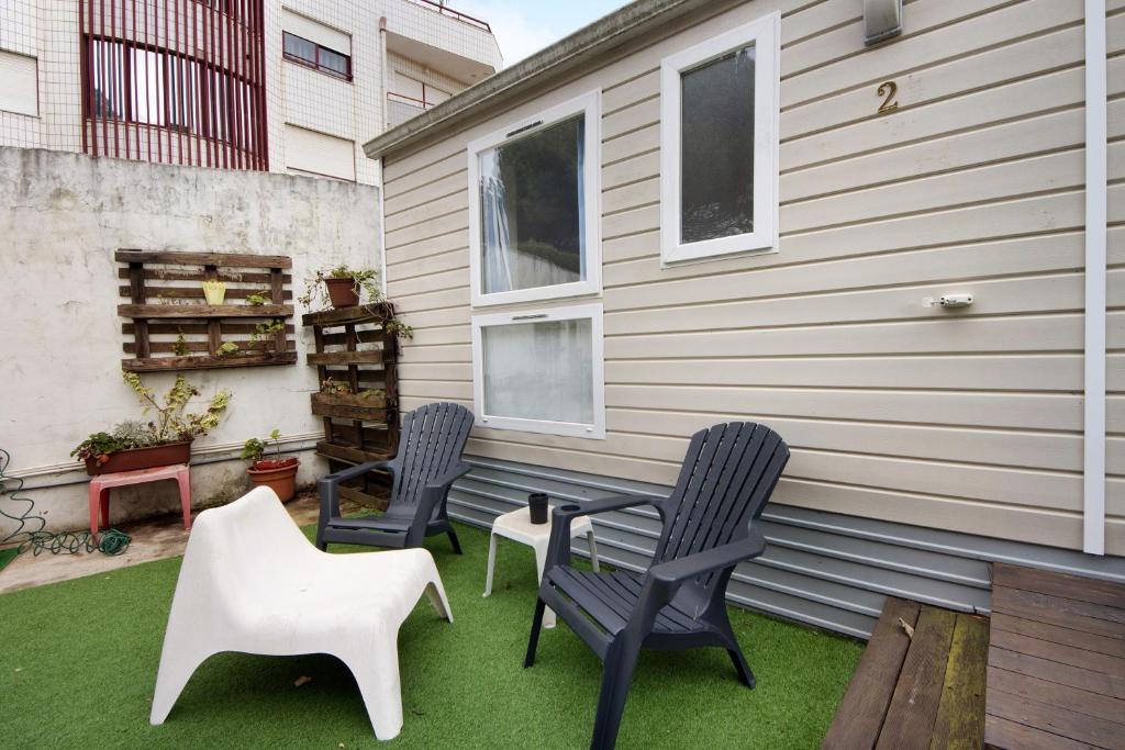 a patio with two chairs and a table and two chairs at Villa Granja Sol 2 in São Félix da Marinha