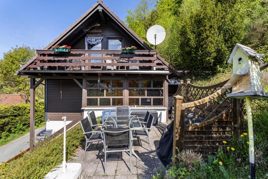 a house with a table and chairs in front of it at Haus Waldesruh in Medebach