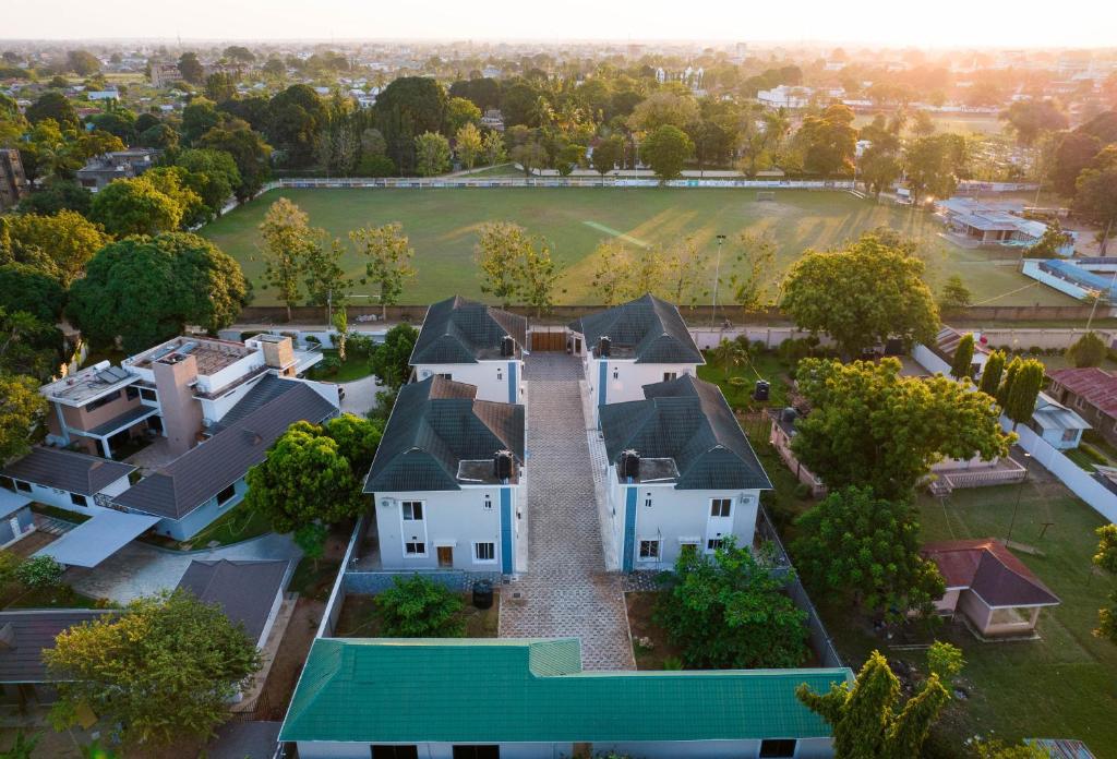 an aerial view of a large white house at Tanga New Apartments in Tanga