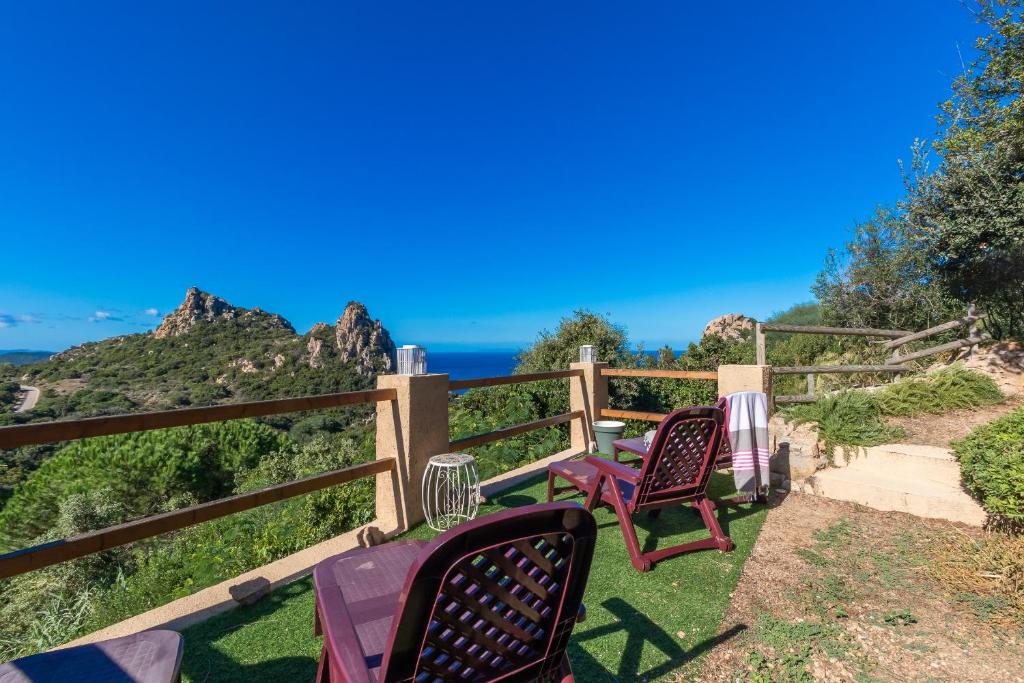 two chairs and a table on a balcony with a view of the ocean at Villa Aloe 2 in Costa Paradiso