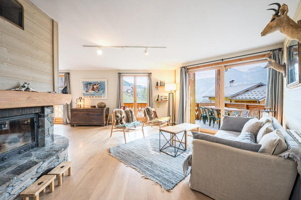 a living room with a couch and a fireplace at Chalet Marmotte in Saint-Martin-de-Belleville