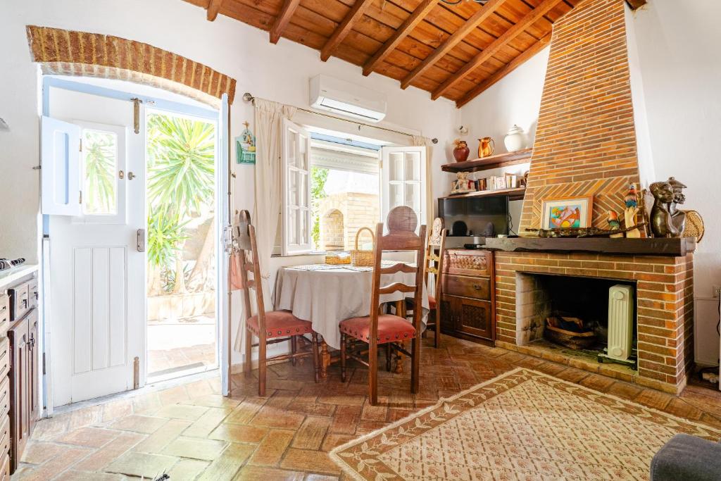 a living room with a table and a fireplace at Casa Da Guia in Beja